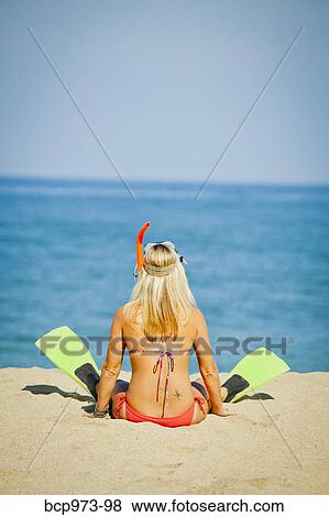 Woman wearing swim fins sitting on beach View Large Photo Image Stock Photo - Woman wearing swim fins sitting on beach. Fotosearch