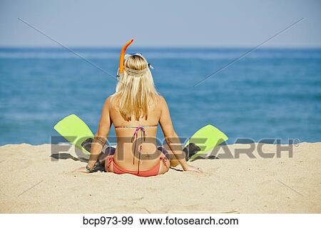 Woman wearing swim fins sitting on beach View Large Photo Image Stock Photo - Woman wearing swim fins sitting on beach. Fotosearch