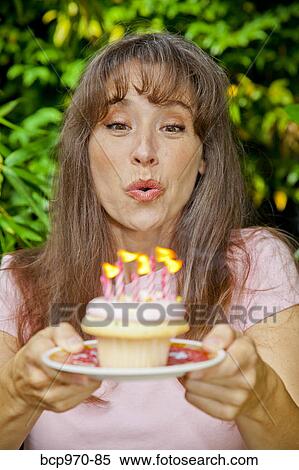 Woman with birthday cupcake View Large Photo Image Stock Photography - Woman with birthday cupcake. Fotosearch