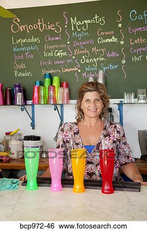 Woman working at smoothie bar View Large Photo Image Stock Photograph - Woman working at smoothie bar. Fotosearch