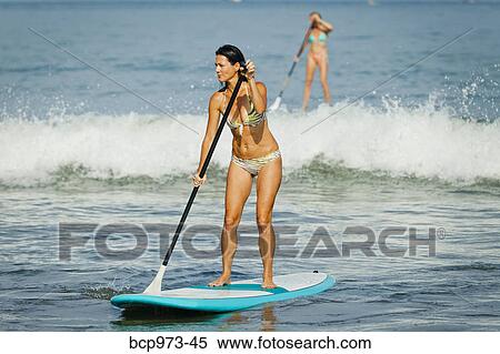 Stock Photography - Women on paddle boards. Fotosearch