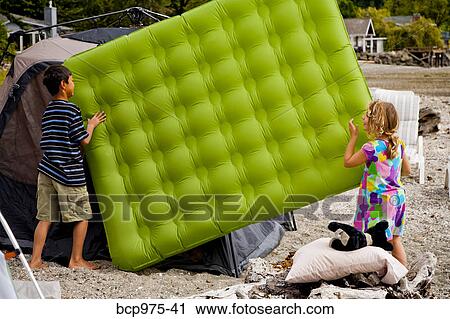 Young children playing in tent on beach View Large Photo Image Stock Image - Young children playing in tent on beach. Fotosearch