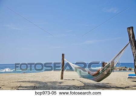 Young man in hammock on beach View Large Photo Image Stock Photography - Young man in hammock on beach. Fotosearch