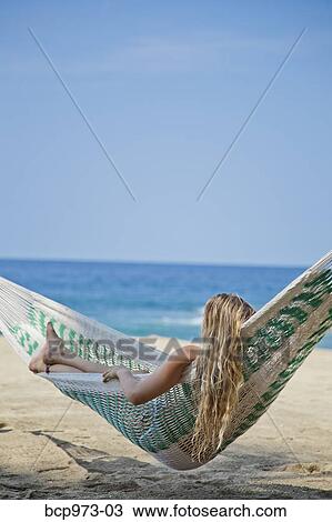 Young woman in hammock on beach View Large Photo Image Stock Image - Young woman in hammock on beach. Fotosearch
