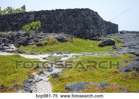Stock Photography - "Ancient masonry wall and a well-worn footpath, Place of Refuge, Hawaii". Fotosearch