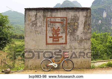 "Bicycle in front of a ""one good deed"" sign" View Large Photo Image Stock Photo - "Bicycle in front of a ""one good deed"" sign". Fotosearch