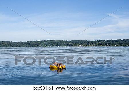 Boy floats in a floatie ring in Puget sound View Large Photo Image Stock Image - Boy floats in a floatie ring in Puget sound. Fotosearch