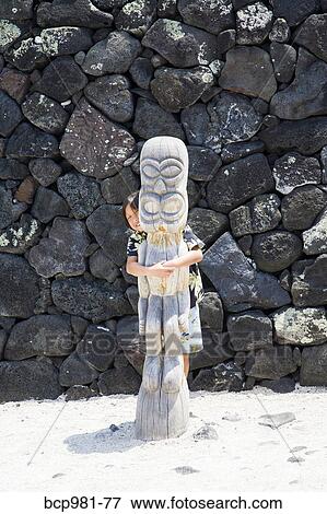 "Boy hugging a carved wooden ki'i, Place of Refuge, Hawaii" View Large Photo Image Stock Photo - "Boy hugging a carved wooden ki'i, Place of Refuge, Hawaii". Fotosearch