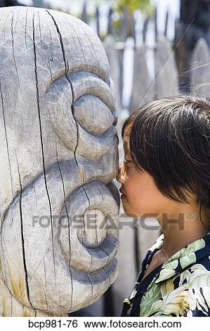 "Boy nose to nose with a carved wooden ki'i, Place of Refuge, Hawaii" View Large Photo Image Stock Photograph - "Boy nose to nose with a carved wooden ki'i, Place of Refuge, Hawaii". Fotosearch