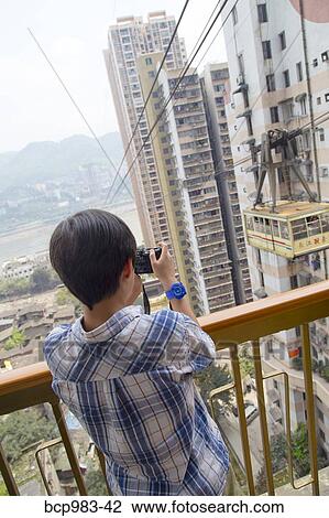 "Boy photographing the Yangtze river cable car, Chongqing, China" View Large Photo Image Stock Image - "Boy photographing the Yangtze river cable car, Chongqing, China". Fotosearch