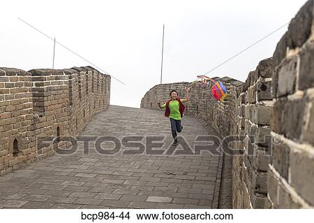 "Boy running with a kite on the Great Wall of China, at Mutianyu, Huairou, China" View Large Photo Image Picture - "Boy running with a kite on the Great Wall of China, at Mutianyu, Huairou, China". Fotosearch