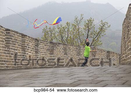 "Boy running with a kite on the Great Wall of China, at Mutianyu, Huairou, China" View Large Photo Image Picture - "Boy running with a kite on the Great Wall of China, at Mutianyu, Huairou, China". Fotosearch