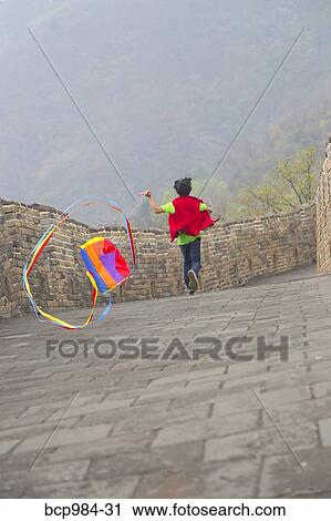 "Boy running with a kite on the Great Wall of China, at Mutianyu, Huairou, China" View Large Photo Image Stock Image - "Boy running with a kite on the Great Wall of China, at Mutianyu, Huairou, China". Fotosearch
