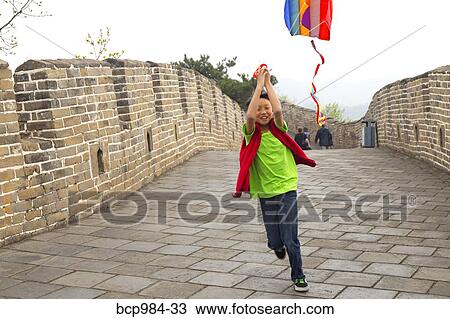 "Boy running with a kite on the Great Wall of China, at Mutianyu, Huairou, China" View Large Photo Image Stock Image - "Boy running with a kite on the Great Wall of China, at Mutianyu, Huairou, China". Fotosearch