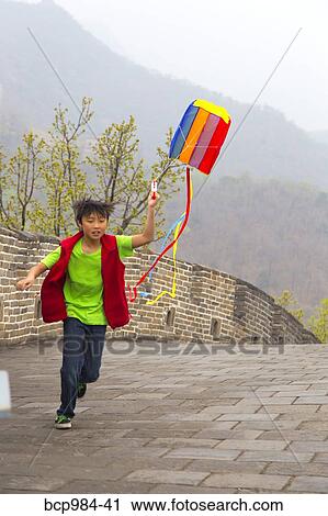 "Boy running with a kite on the Great Wall of China, at Mutianyu, Huairou, China" View Large Photo Image Stock Image - "Boy running with a kite on the Great Wall of China, at Mutianyu, Huairou, China". Fotosearch