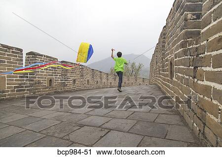 "Boy running with a kite on the Great Wall of China, at Mutianyu, Huairou, China" View Large Photo Image Stock Image - "Boy running with a kite on the Great Wall of China, at Mutianyu, Huairou, China". Fotosearch