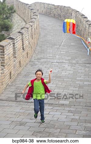 "Boy running with a kite on the Great Wall of China, at Mutianyu, Huairou, China" View Large Photo Image Stock Photo - "Boy running with a kite on the Great Wall of China, at Mutianyu, Huairou, China". Fotosearch