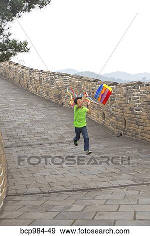 "Boy running with a kite on the Great Wall of China, at Mutianyu, Huairou, China" View Large Photo Image Stock Photo - "Boy running with a kite on the Great Wall of China, at Mutianyu, Huairou, China". Fotosearch
