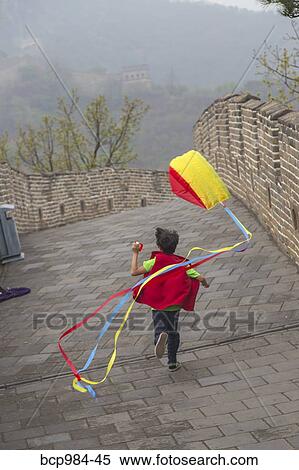 "Boy running with a kite on the Great Wall of China, at Mutianyu, Huairou, China" View Large Photo Image Stock Photography - "Boy running with a kite on the Great Wall of China, at Mutianyu, Huairou, China". Fotosearch