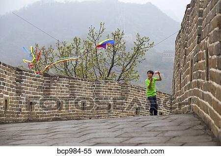 Stock Photography - "Boy running with a kite on the Great Wall of China, at Mutianyu, Huairou, China". Fotosearch