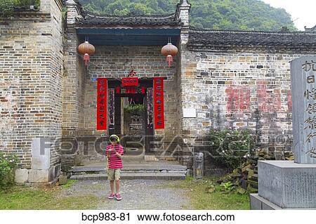 Boy wearing headphones uses an electronic device in a rural Chinese village View Large Photo Image Stock Image - Boy wearing headphones uses an electronic device in a rural Chinese village. Fotosearch
