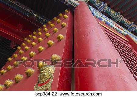 Stock Image - "Close up of the ornate red and gold palace gates in the Forbidden City, Beijing, China". Fotosearch