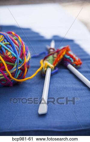 Colorful knitting on a blue cushion View Large Photo Image Stock Image - Colorful knitting on a blue cushion. Fotosearch