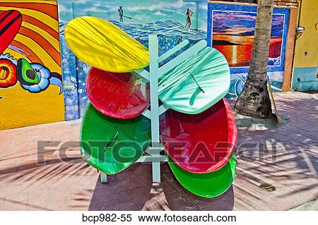 Colorful stand-up paddle boards on a rack View Large Photo Image Stock Photography - Colorful stand-up paddle boards on a rack. Fotosearch