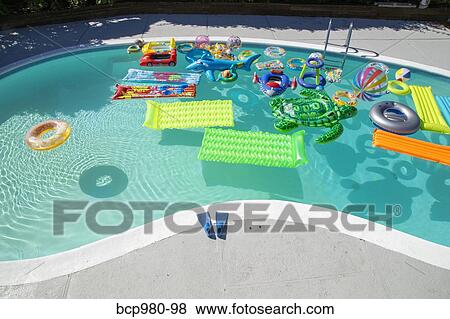 Family pool full of inflatable toys View Large Photo Image Stock Photo - Family pool full of inflatable toys. Fotosearch