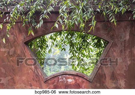 Looking through a window into a garden at a monastery at Leshan Giant Buddha View Large Photo Image Stock Photograph - Looking through a window into a garden at a monastery at Leshan Giant Buddha. Fotosearch