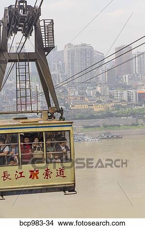 "Passengers ride in a cable car over the Yangtze river, Chonqing, China" View Large Photo Image Picture - "Passengers ride in a cable car over the Yangtze river, Chonqing, China". Fotosearch