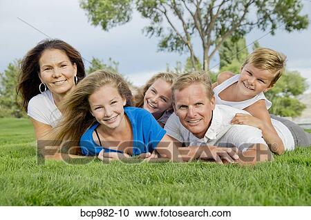 Portrait of a family of five in a dog pile near a lake View Large Photo Image Stock Image - Portrait of a family of five in a dog pile near a lake. Fotosearch