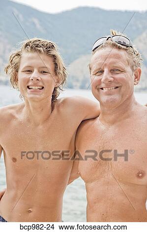 Portrait of a father and son near a lake View Large Photo Image Picture - Portrait of a father and son near a lake. Fotosearch