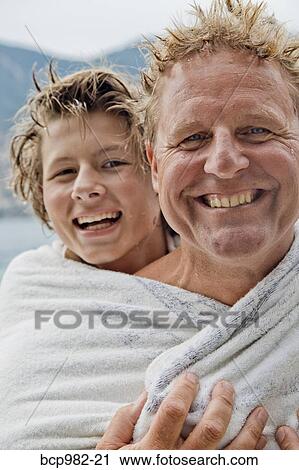Portrait of a father and son wrapped in a towel View Large Photo Image Stock Image - Portrait of a father and son wrapped in a towel. Fotosearch