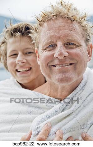 Portrait of a father and son wrapped in a towel View Large Photo Image Stock Image - Portrait of a father and son wrapped in a towel. Fotosearch