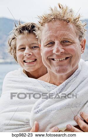 Portrait of a father and son wrapped in a towel View Large Photo Image Stock Image - Portrait of a father and son wrapped in a towel. Fotosearch