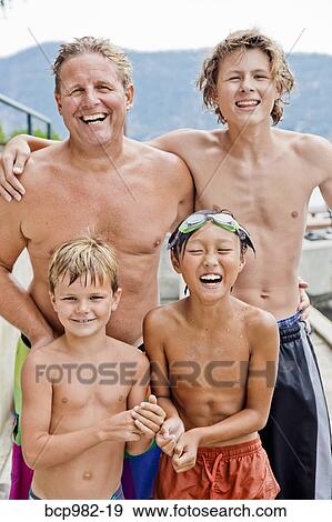 Portrait of a man and three boys in swimming trunks View Large Photo Image Stock Photo - Portrait of a man and three boys in swimming trunks. Fotosearch