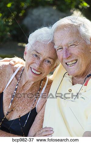 Portrait of a senior couple sitting outdoors View Large Photo Image Stock Photo - Portrait of a senior couple sitting outdoors. Fotosearch