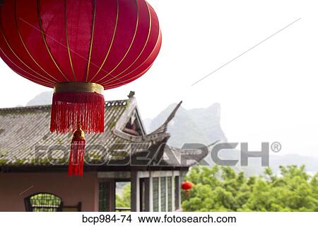 Picture - "Red lantern hanging in front of a temple, Yangshuo, China". Fotosearch
