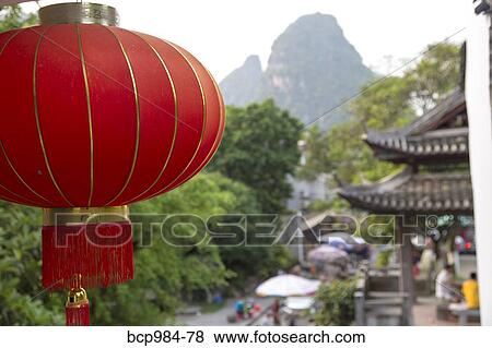 Stock Photo - "Red lantern hanging in front of a temple, Yangshuo, China". Fotosearch