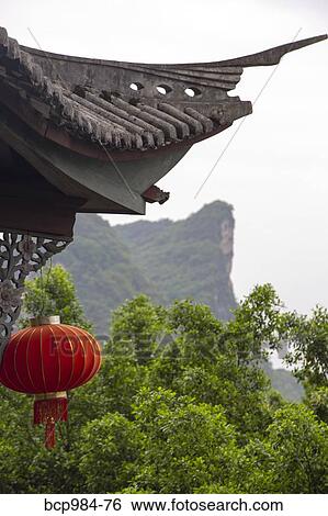 Stock Photograph - "Red lantern hanging in front of a temple, Yangshuo, China". Fotosearch
