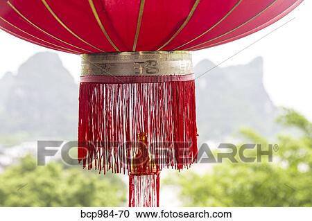 "Red lantern hanging in front of a view of the Karst mountains and Li River, Yangshuo, China" View Large Photo Image Stock Image - "Red lantern hanging in front of a view of the Karst mountains and Li River, Yangshuo, China". Fotosearch