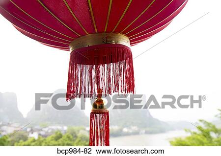 "Red lantern hanging in front of the Li River, Yangshuo, China" View Large Photo Image Stock Image - "Red lantern hanging in front of the Li River, Yangshuo, China". Fotosearch