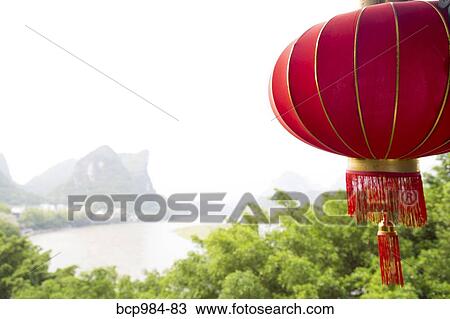 "Red lantern hanging in front of the Li River, Yangshuo, China" View Large Photo Image Stock Image - "Red lantern hanging in front of the Li River, Yangshuo, China". Fotosearch