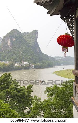 Stock Photo - "Red lantern hanging in front of the Li River, Yangshuo, China". Fotosearch