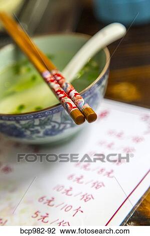 Soup bowl and chopsticks at a Chinese restaurant View Large Photo Image Stock Image - Soup bowl and chopsticks at a Chinese restaurant. Fotosearch