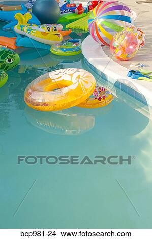 Swimming pool full of inflatable toys View Large Photo Image Picture - Swimming pool full of inflatable toys. Fotosearch