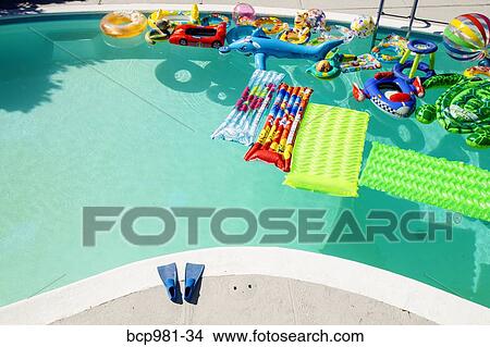Swimming pool full of inflatable toys View Large Photo Image Picture - Swimming pool full of inflatable toys. Fotosearch