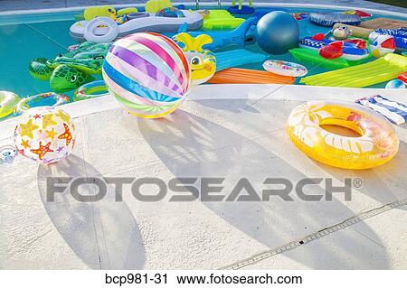 Swimming pool full of inflatable toys View Large Photo Image Stock Image - Swimming pool full of inflatable toys. Fotosearch