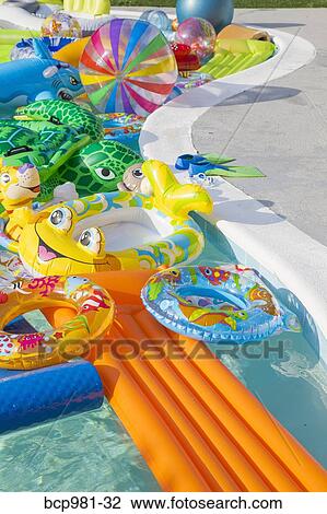Swimming pool full of inflatable toys View Large Photo Image Stock Image - Swimming pool full of inflatable toys. Fotosearch